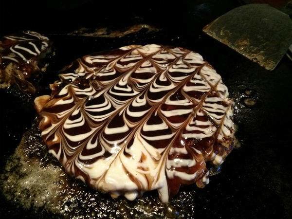 Japanese food:Okonomiyaki. Okonomiyaki are savory Japanese pancakes filled with meat, seafood and vegetables. They can be topped with mayonnaise, katsuobushi, n