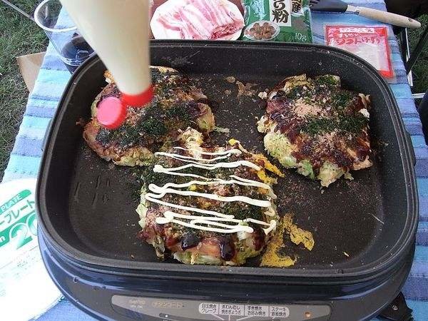 Japanese food:Okonomiyaki. Okonomiyaki are savory Japanese pancakes filled with meat, seafood and vegetables. They can be topped with mayonnaise, katsuobushi, n